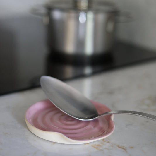Blush pink ceramic spoon rest from Katie L Thompson Designs, designed to hold cooking utensils in the kitchen.