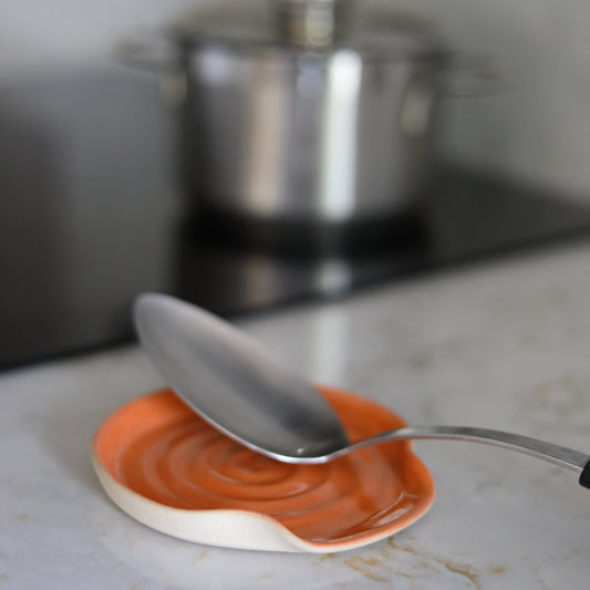 Mandarin orange ceramic spoon rest by Katie L Thompson Designs, featuring a vibrant citrus design for kitchen use.