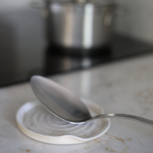 Pepper white ceramic spoon rest by Katie L Thompson Designs, designed to keep kitchen countertops clean while cooking.