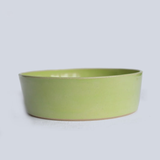 Spring green ceramic pasta bowl by Katie L Thompson Designs, featuring a classic round shape and vibrant spring-inspired color.