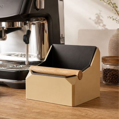 Square coffee knock box with real oak knock bar by KNOCDIC®, shown in a modern kitchen setting.