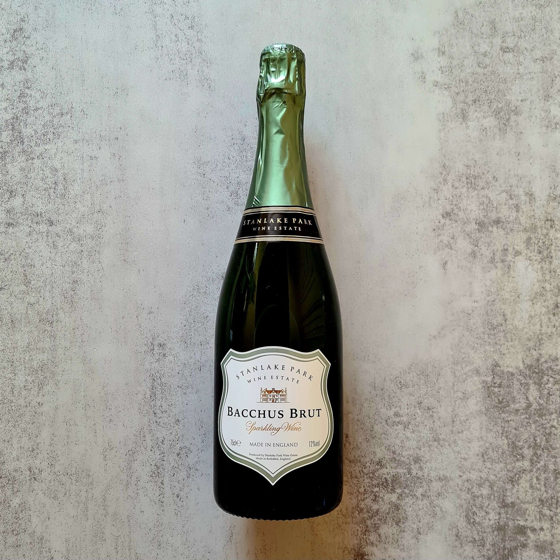 Bray Cured Bacchus Brut sparkling wine and a trio of British charcuterie in a hamper, featuring ham, cured meats, and gourmet accompaniments.