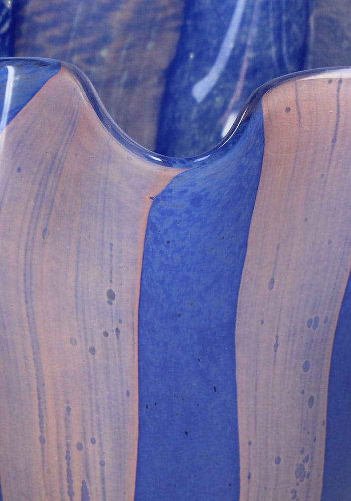 Striped scalloped blue and pink glass vase by Casa by Josephine Jenno, decorative flower holder with wavy edges.