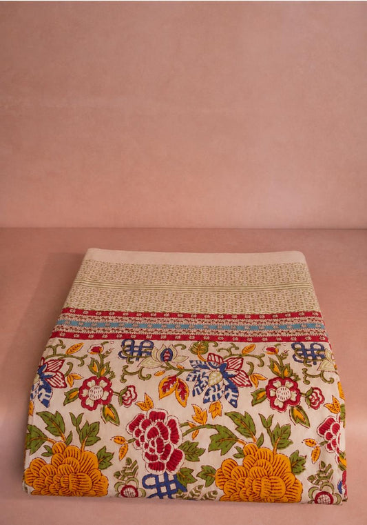 Casa by Josephine Jenno blooming spring tablecloth with colorful floral pattern on fabric surface.