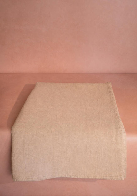 Casa by Josephine Jenno Emma linen tablecloth in oatmeal, showcasing a soft, textured fabric draped on a dining table.
