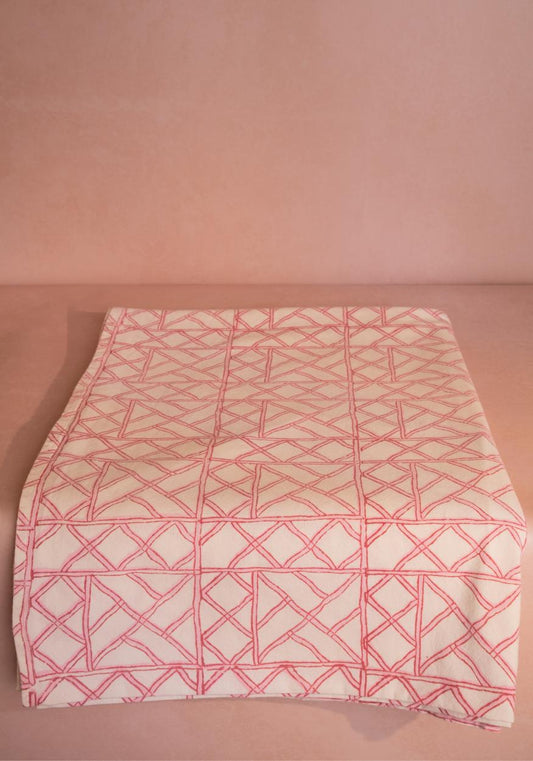 Pink bamboo lattice tablecloth by Casa by Josephine Jenno, featuring a delicate pink pattern ideal for elegant dining settings.