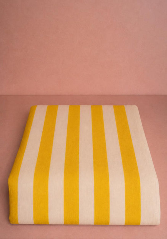 Yellow striped Lucinda linen tablecloth with a classic design, perfect for adding a touch of elegance to your dining table.
