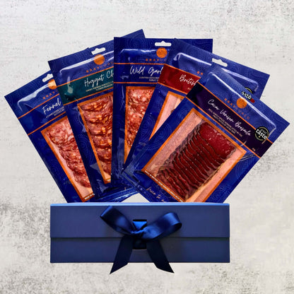 Assorted Taste of Bray Cured charcuterie selection with five packs of cured meats, displayed in a wooden serving tray.