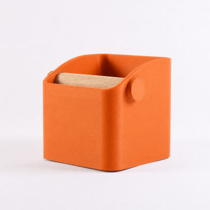 Orange KNOCDIC® Square Espresso Knock Box with oak knock bar for easy coffee grounds disposal.