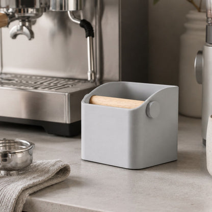 KNOCDIC® Square Espresso Knock Box with oak knock bar on countertop, used for knocking out spent coffee grounds.