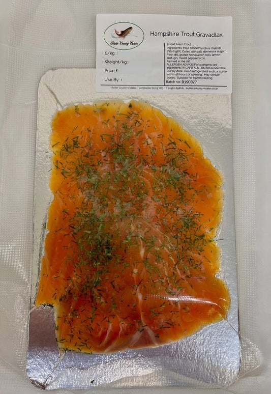 Slices of artisan-crafted trout gravadlax on a plate, showcasing the delicate pink fish prepared by Butler Country Estates.