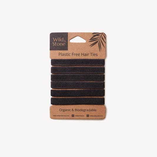 Six black plastic-free hair ties from Wild And Stone, shown in a pack, made from eco-friendly, sustainable materials for gentle hair hold.