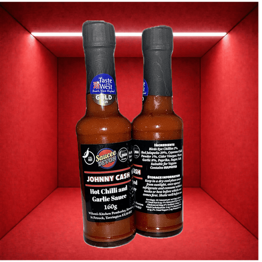 Wilson’s Kitchen artisan chili sauce with hot chili and garlic, featuring vibrant red sauce in a glass jar.