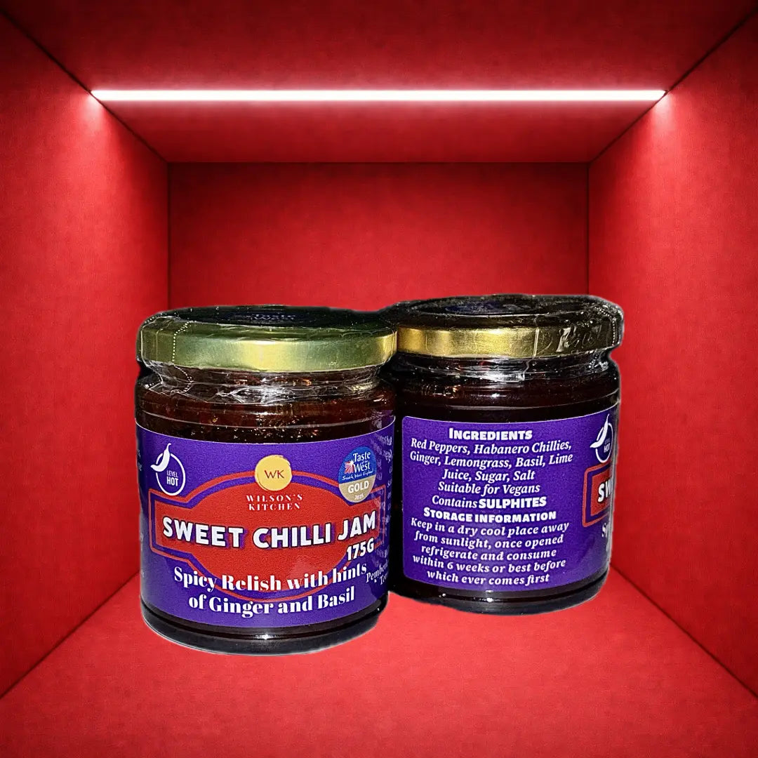 Award-winning Wilson’s Kitchen hot sweet chilli jam in a jar with visible red chili peppers and glossy, thick consistency.