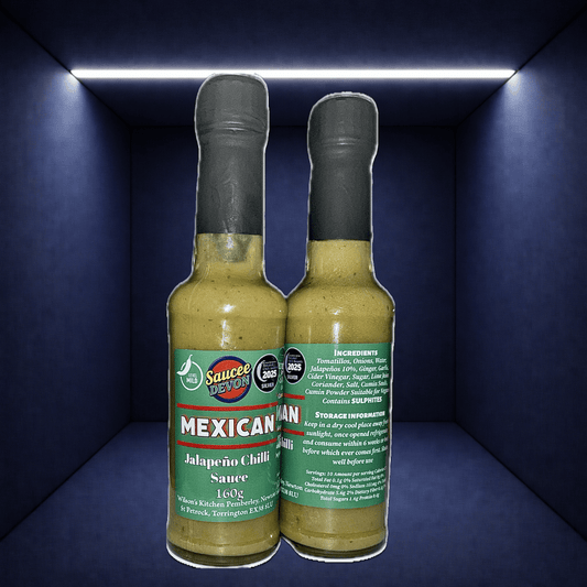 Wilson’s Kitchen Mexican Jalapeño Sauce bottle with label, showcasing vibrant jalapeño peppers and spicy chili sauce.