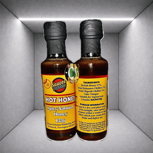 Wilson’s Kitchen hot honey in a glass jar, artisan chili sauce with a sweet and spicy flavor, ready to drizzle or add to dishes.