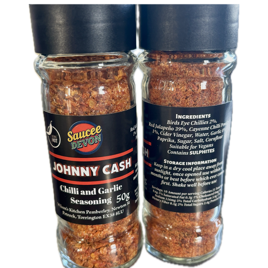 Wilson’s Kitchen hot chilli and garlic seasoning in a jar, featured with chili peppers and garlic cloves for artisan chilli sauce.