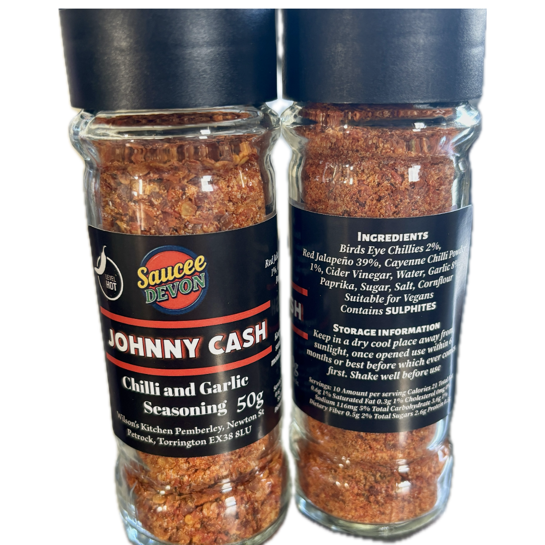 Wilson’s Kitchen hot chili and garlic seasoning in a jar, showcasing vibrant red chili peppers and fresh garlic cloves.