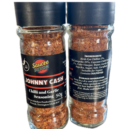 Wilson’s Kitchen hot chili and garlic seasoning in a jar, showcasing vibrant red chili peppers and fresh garlic cloves.