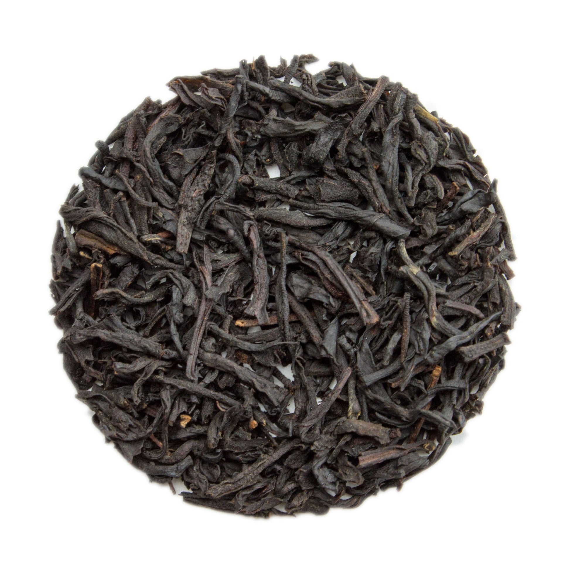 Cup of vanilla black tea by PekoeTea Edinburgh, showcasing a dark brewed tea infused with vanilla flavor in a clear glass mug.