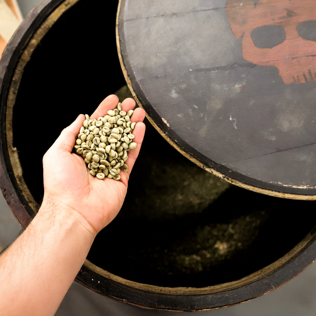 Skull Crusher Coffee Barrel Aged Coffee Beans in whisky cask, highlighting rich, dark roasted beans with barrel-aging effects.