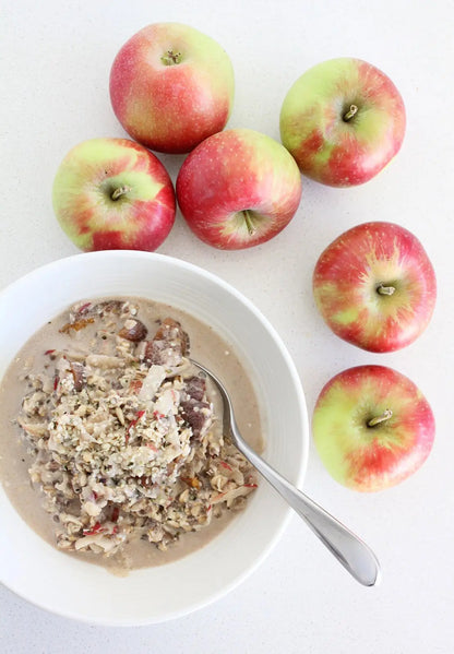 Whole Food Earth Apple & Apricot Muesli cereal in a bowl, showing dried fruits and crunchy oats, vegan and GMO-free.