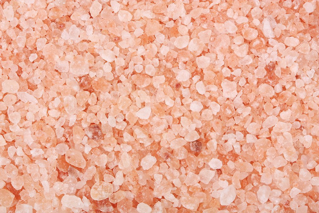 Unrefined coarse Himalayan salt crystals from Whole Food Earth, showing natural pink mineral-rich salt for culinary and health use.