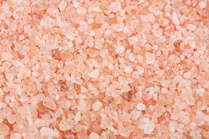 Unrefined coarse Himalayan salt crystals from Whole Food Earth, showing natural pink mineral-rich salt for culinary and health use.