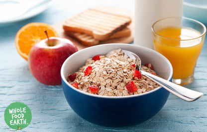 Whole Food Earth Country Muesli cereal with flakes, dried fruit, nuts, and seeds in a bowl, showcasing a healthy, vegan breakfast option.