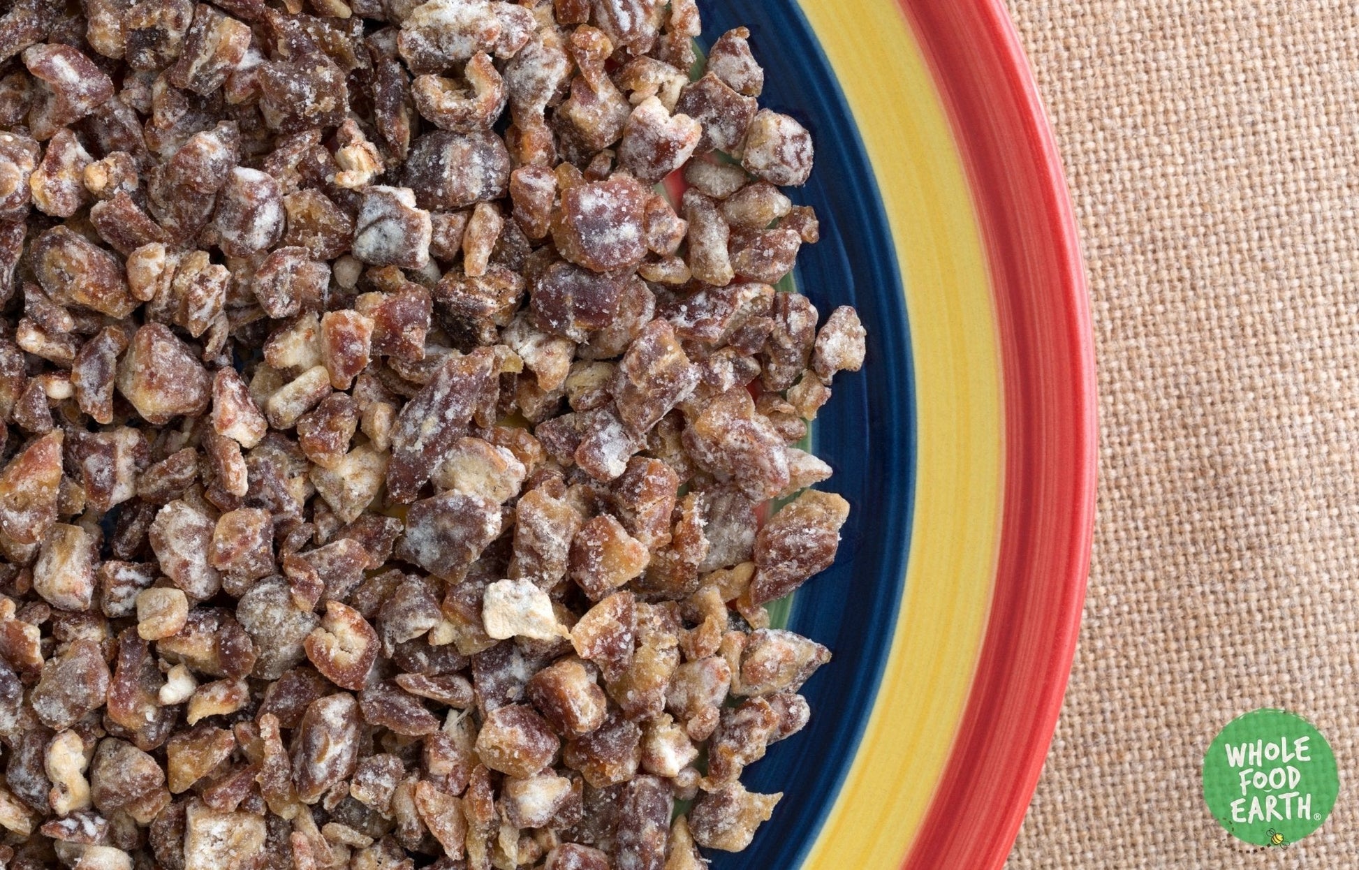 Chopped dried dates from Whole Food Earth, GMO-free, vegan, dairy-free, with no added sugar, in a clear container.
