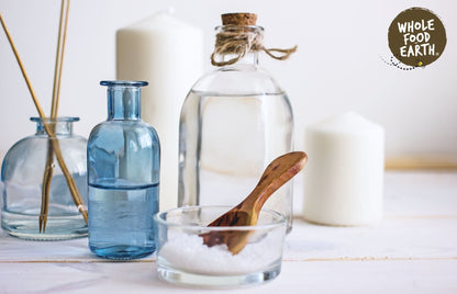 Whole Food Earth Epsom Bath Salts, additive-free mineral salts for relaxing bath experience, shown in a clear container.