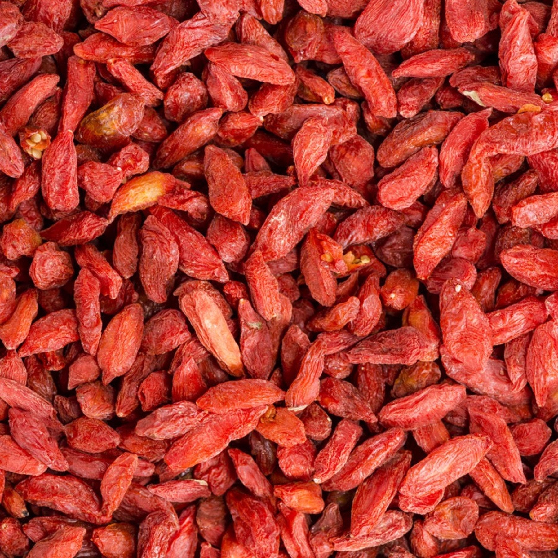 Dried Goji Berries from Whole Food Earth, GMO-free raw sun-dried red berries, close-up of dried fruit on a white background.
