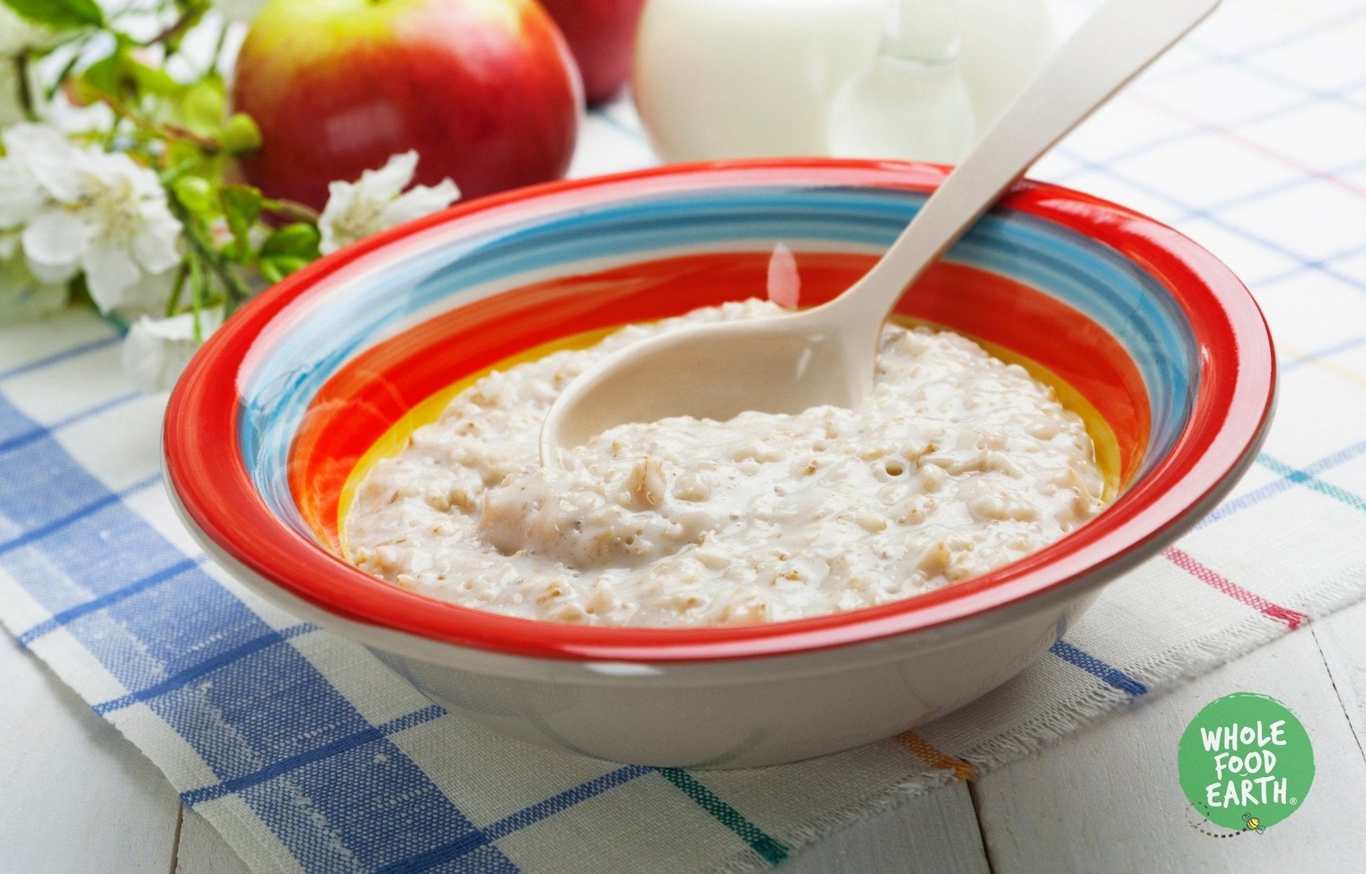 Medium oatmeal cereal from Whole Food Earth, GMO-free, vegan, dairy-free, with no added sugar, displayed in a bowl.