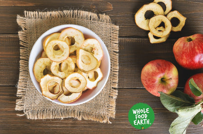 Organic dried apple rings by Whole Food Earth, showing golden, sliced apple fruit pieces in a natural, wholesome presentation.