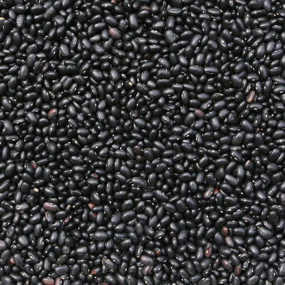 Organic black turtle beans from Whole Food Earth, raw and GMO-free, in a close-up shot showing their glossy black appearance.