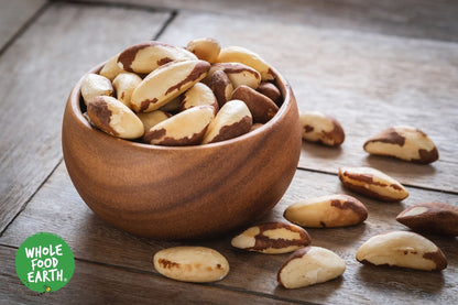 Whole Food Earth organic Brazil nuts in a bowl, showing their large, smooth, light brown shells, GMO-free and raw.