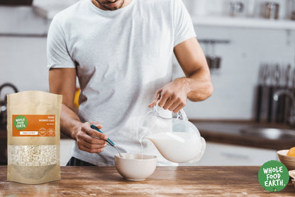 Organic Buckwheat Flakes cereal from Whole Food Earth, raw and GMO-free, displayed in a bowl with a spoon.
