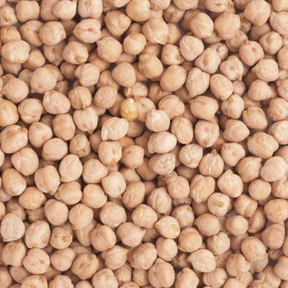 Organic chickpeas from Whole Food Earth, display of light tan, dried legumes in a bowl on a rustic wooden surface.