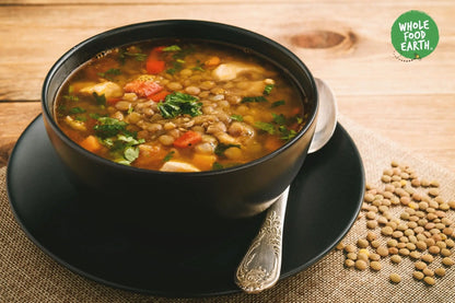 Whole Food Earth organic green lentils, GMO-free beans and pulses in a close-up image showing their fresh, vibrant green appearance.