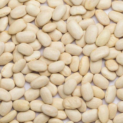 Raw organic haricot beans from Whole Food Earth, dried and GMO-free, shown in a close-up of light beige beans.