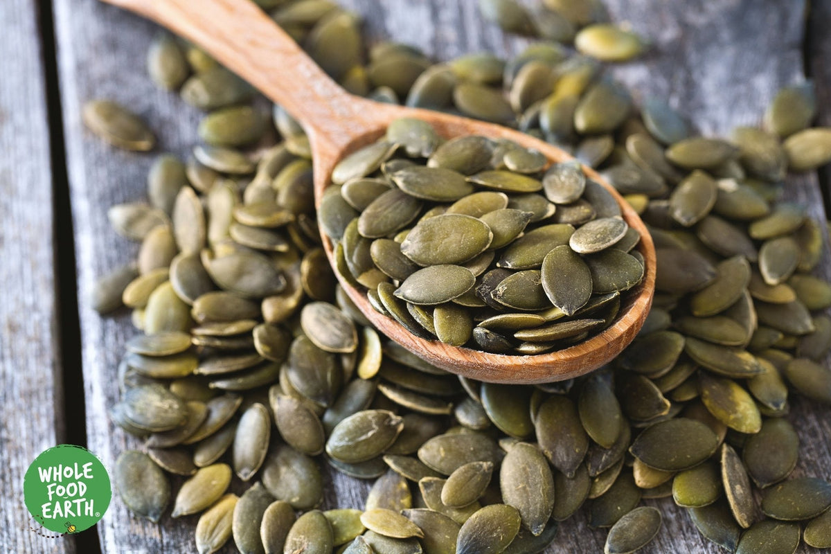 Organic pumpkin seeds from Whole Food Earth, raw, GMO-free, vegan nuts and seeds product, shown in a close-up image.