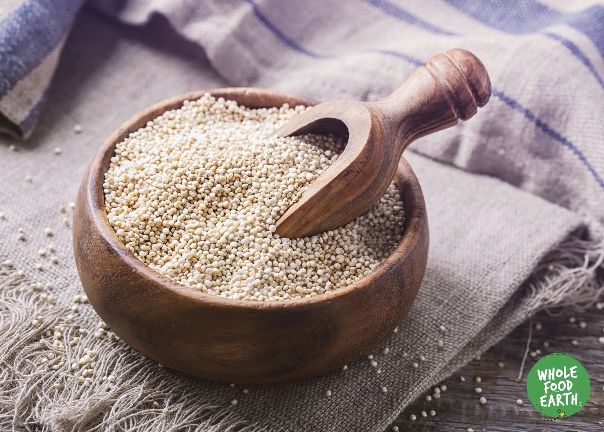 Raw organic quinoa grains from Whole Food Earth, GMO-free, in a clear bowl showing light, fluffy quinoa suitable for cooking.