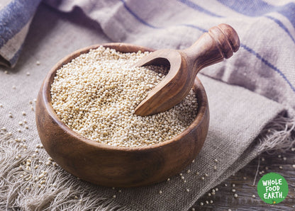 Raw organic quinoa grain from Whole Food Earth, GMO-free, shown in a close-up image highlighting its small, tan seeds.