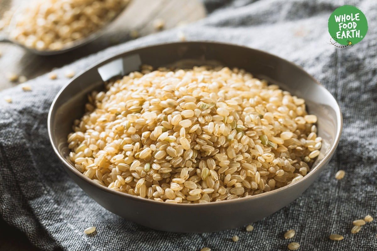 Organic short grain brown rice from Whole Food Earth, showing a close-up of uncooked rice grains in a bowl.