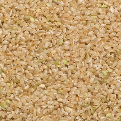 Organic short grain brown rice from Whole Food Earth, GMO-free, shown in a clear bag with rice grains visible.