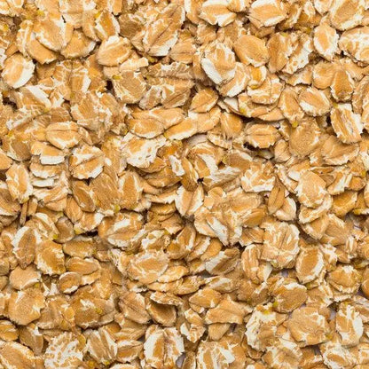 Organic Spelt Flakes cereal by Whole Food Earth, close-up of toasted spelt flakes in a bowl on a wooden surface.
