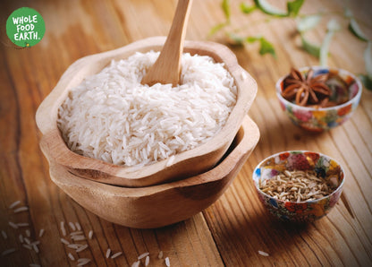 Organic White Basmati Rice from Whole Food Earth, showing long, slender grains in a clear bag, GMO-free, ideal for flavorful dishes.