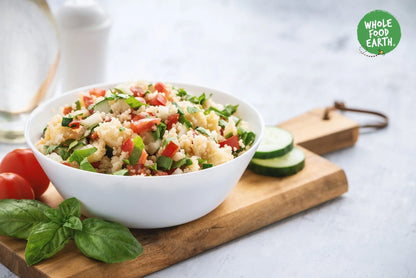 Raw organic white couscous from Whole Food Earth, GMO-free, vegan, and additive-free, with a close-up of the uncooked grains.