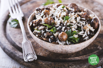 Raw organic wild rice from Whole Food Earth, showcasing long, dark grains in a natural, uncooked state for healthy vegan cooking