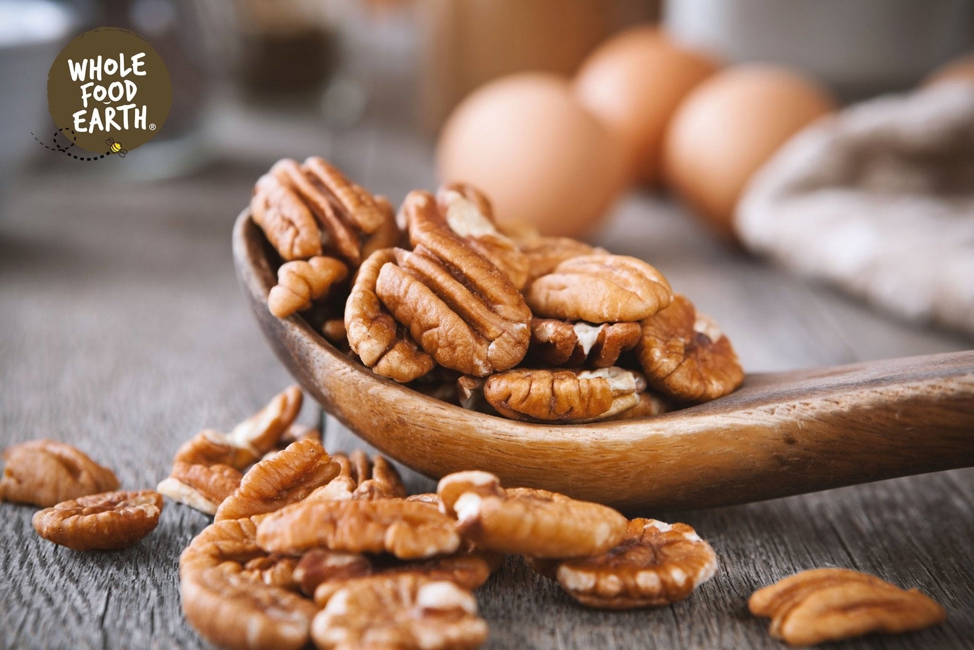 Raw Whole Food Earth Pecan Halves, GMO-free nuts and seeds, showcasing golden-brown pecan halves on a neutral background.